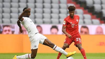 Bayern Munich forward Kingsley Coman (R) and Frankfurt defender Evan N'Dicka vie for the ball. AFP