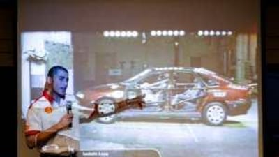 Basil Shaaban demonstrates the value of wearing seat belts to his student audience.