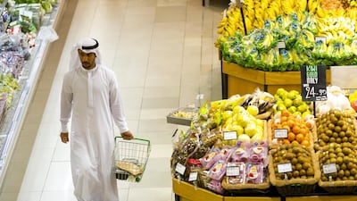 A shopper walks through the fresh produce section of Spinneys' Karama shop in Dubai. Christopher Pike / The National Reporter