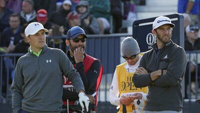 Jordan Spieth, left, is five shots behind Dustin Johnson, right, at the halfway stage of The Open Championship. David J. Phillip / AP Photo