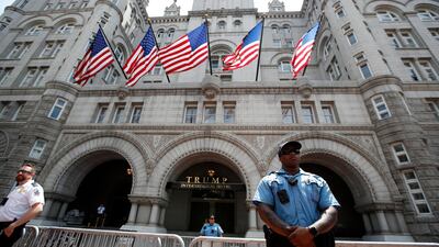 Law enforcement officers stand guard in front of the Trump Hotel in Washington. AP