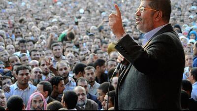 Egyptian President Mohammed Morsi speaks to supporters outside the Presidential palace in Cairo on November 23, 2012. AP Photo