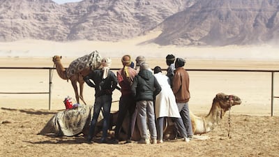 Jordanian Bedouins watch the camels race using robotic jockeys at the Sheikh Zayed track in the town of al-Disi in the desert of Wadi Rum valley, on November 9, 2019