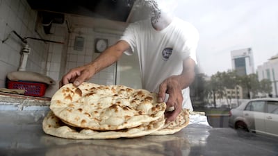 Fresh flat bread prepared at a bakery in Abu Dhabi. Silvia Razgova / The National