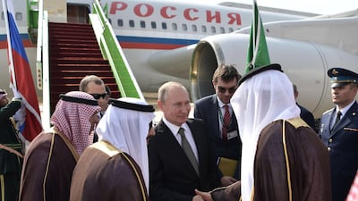 Russian President Vladimir Putin, centre, is welcomed on arrival in Riyadh, Saudi Arabia. EPA