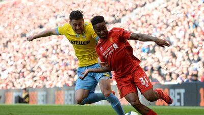 Liverpool's Raheem Sterling dribbles past Crystal Palace's Joel Ward during their Premier League contest on Saturday. Oli Scarff / AFP / May 16, 2015