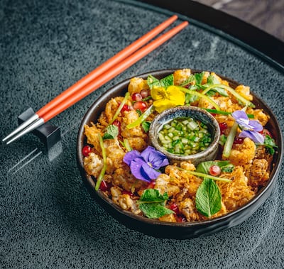 The sharing-style squid starter comes with a sweet chilli sauce made from green chillies. Photo: Tattu Restaurant Dubai