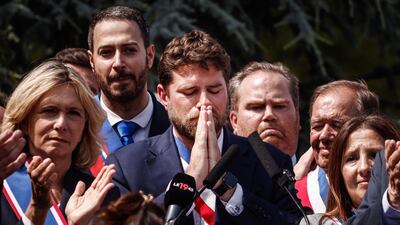 Vincent Jeanbrun, centre, the mayor of L'Hay-les-Roses, during Monday's rally after an attack on his house in the south of Paris. EPA