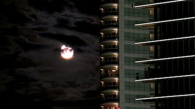 The supermoon sits among the clouds over the Beirut skyline in Lebanon. Nabil Mounzer / EPA