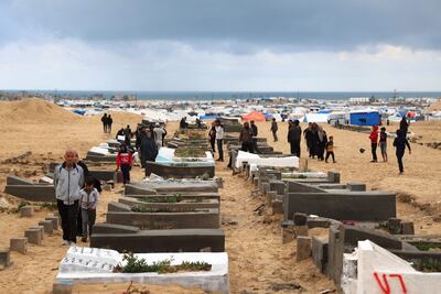 Palestinians visit the graves of loved ones at the start of the Eid Al Fitr festival on Wednesday. AFP