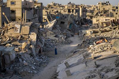 Palestinians walk through the destruction left by the Israeli air and ground offensive on Khan Younis, Gaza Strip, on September 12. AP