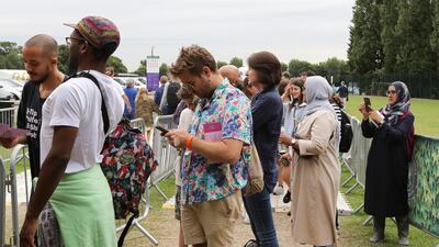 Tennis fans go the old-fashioned route and wait in a queue to get tickets to enter the Wimbledon Tennis Championships in London. AP