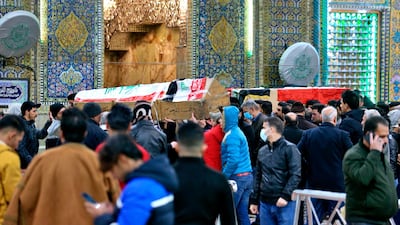 Mourners carry flag-draped coffins of victims at the Imam Ali shrine in Najaf, Iraq. AP