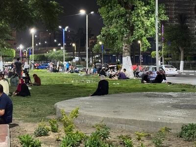 Cairo residents lounge on the grass and enjoy picnics as they catch the evening breeze by Al Qubba Palace. Kamal Tabikha / The National