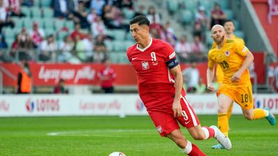 Poland forward Robert Lewandowski runs with the ball. AFP