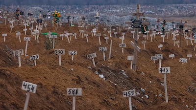 Numbers mark the graves of unidentified people killed during fighting, in Mariupol in 2022. EPA