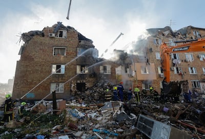 Ukrainian rescuers work at the site of a Russian strike on a five-storey residential building in Kyiv. EPA