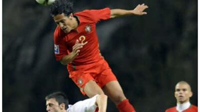 Portugal's Bruno Alves challenges Albania's Klodian Duro.