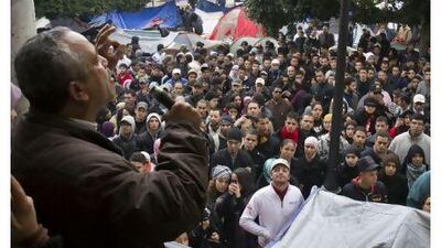 Demonstrators listen to a speaker in a protest camp in the Kasba in Tunis yesterday as unrest continued across Tunisia.