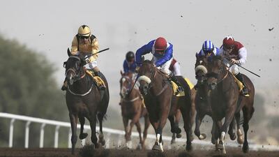Jockey Silvestre De Sousa (yellow) wins race 3 with his horse Interpret at Jebel Ali Racecourse. Sarah Dea / The National