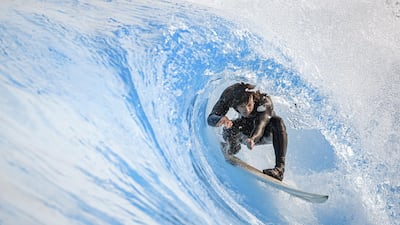Surfer Vincent Schneider rides an artificial wave in the "Alaia Bay" wavepool in Sion, Switzerland, on Tuesday, April 27. EPA