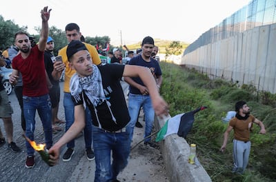 A supporter of Hezbollah and the Palestinian revolution faction prepares to throw a petrol bomb. EPA