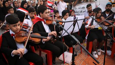 Music school students take part in the protests near the Basra provincial council building. AP