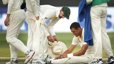 Mitchell Starc sits on the ground after getting cramp in his legs during Day 1 of the Test between Australia and Pakistan in Dubai. Getty Images
