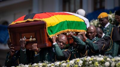 The casket of former president Robert Mugabe is carried by the presidential guard to an air force helicopter for transport to a stadium where it will lie in state, at his official residence in the capital Harare, Zimbabwe. The ongoing uncertainty of the burial of Mugabe, who died last week in Singapore at the age of 95, has eclipsed the elaborate plans for Zimbabweans to pay their respects to the former guerrilla leader at several historic sites. AP Photo