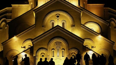 People walk in front of the Holy Trinity Cathedral during midnight Christmas service in Tbilisi, Georgia. David Mdzinarishvili / Reuters