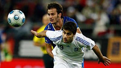 Italy's Alberto Gilardino jostles with Greece's Sokratis Papstathopoulous.