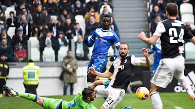 Juventus' Gonzalo Higuain and Brescia's Enrico Alfonso vie for the ball. AP