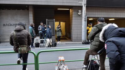 Members of the media wait outside an entrance to the offices of the Japanese lawyers for former Nissan chief Carlos Ghosn in Tokyo. AFP