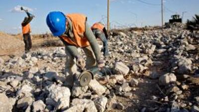 Workers clear rubble from buildings to be reused as construction materials in Gaza City. Repairs have been slowed because of controls on materials that cross the border.