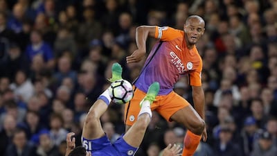 Manchester City's Vincent Kompany, right, fights for the ball with Chelsea's Diego Costa. Alastair Grant / AP