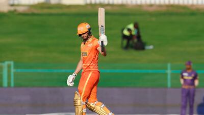 James Vince of Gulf Giants raises his bat after scoring 50