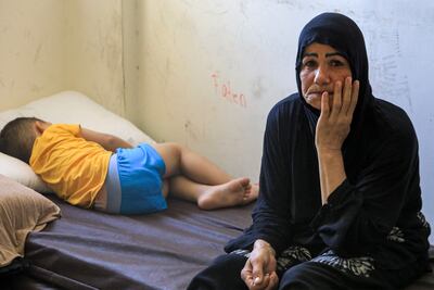 Members of a family displaced by fighting in the south of Lebanon between Israel and Hezbollah take refuge at a school that has been turned into a shelter in Beirut on Tuesday. AFP