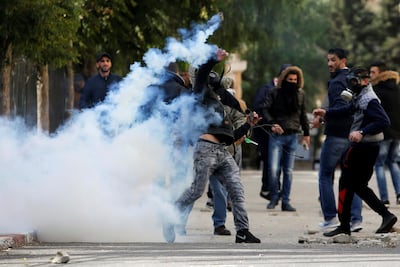 A Palestinian protester hurls back a tear gas canister fired by Israeli troops during clashes in the West Bank city of Bethlehem on December 7, 2017. Reuters