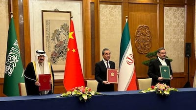 Saudi Minister of State and National Security Adviser Musaed Al Aiban, left, meets Iran's Secretary of the Supreme National Security Council Rear Admiral Ali Shamkhani, right, and China's top diplomat Wang Yi in Beijing on March 10. SPA / Reuters
