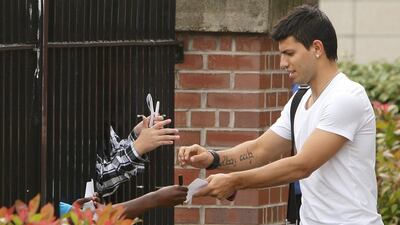 Sergio Aguero signs autographs after completing his medical following his move to Manchester City in July, 2011. PA