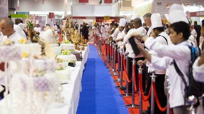 Chefs and visitors take photos of food on display at the SIAL Middle Eastern Food Exhibition. Lee Hoagland / The National