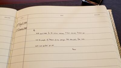 Pope Francis leaves a message when signing the visitors book in Aras an Uachtarain. EPA