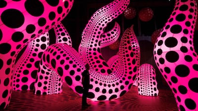 A man admires an artwork entitled 'A Bouquet of Love I Saw in the Universe' which features in an exhibition by Kusama in Manchester, UK. AFP