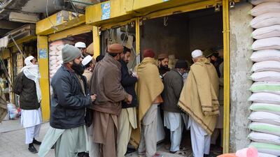 People line up outside a shop to buy flour. The shortage has drawn serious criticism of Imran Khan’s government.