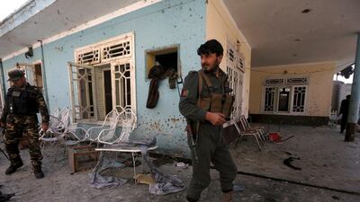 Afghan security forces inspect the site of a suicide attack in Jalalabad at the home of a tribal elder which killed 14 people on Sunday. REUTERS/ Parwiz