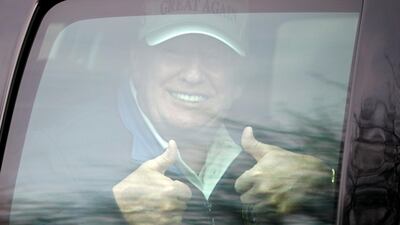 U.S. President Donald Trump gives a thumbs up as his motorcade leaves the Trump National Golf Club in Sterling, Virginia. Reuters