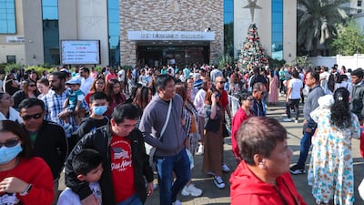 Churchgoers spill out into the grounds of St Joseph’s Cathedral in Abu Dhabi. Victor Besa / The National