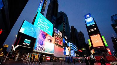 Screens in New York City's Times Square are lit up in blue as part of an initiative to honour medical workers dealing with the coronavirus pandemic. Reuters