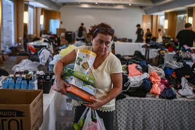 A woman carries toys for children from donations at a hotel in Eilat. AFP