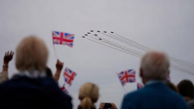 People look at a flypast during the commemorations for the 75th Anniversary of the D-Day landings in Southsea Common, Portsmouth, Hampshire. EPA